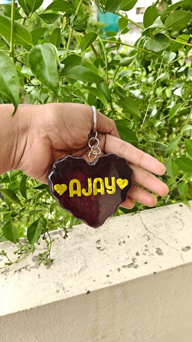 Heart resin keychain with the name Ajay in gold