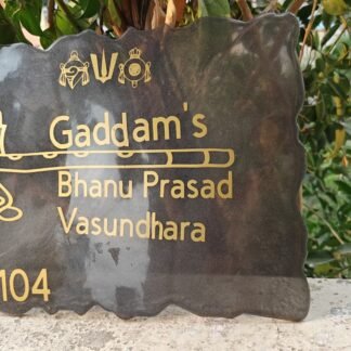 Dark resin house nameplate with gold lettering