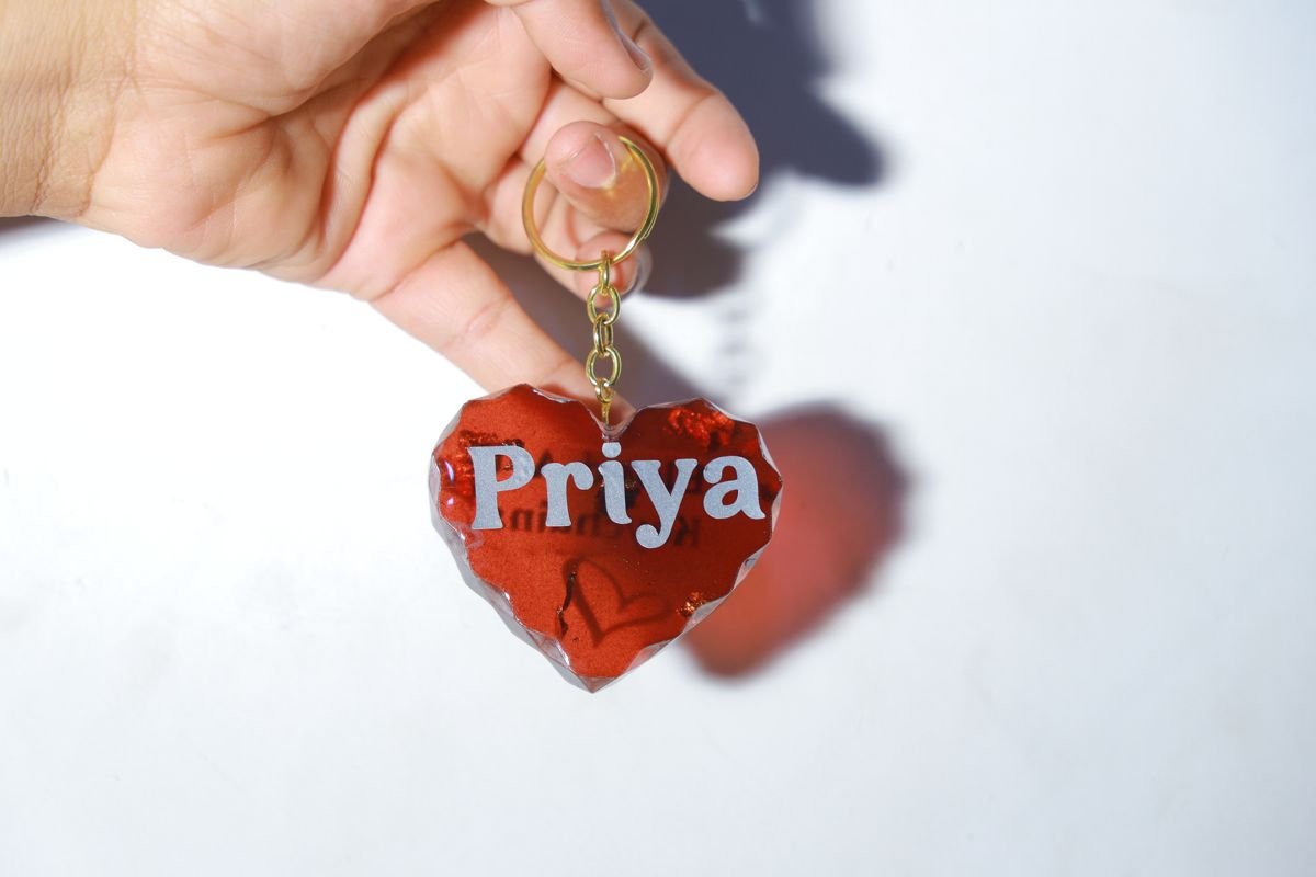 Red heart resin keychain with the name Priya