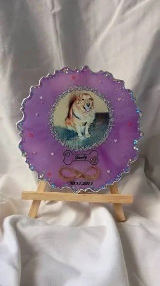 Purple resin pet memorial frame with a dog photo and a bone name tag