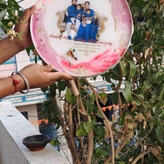Round pink resin photo frame held in a hand