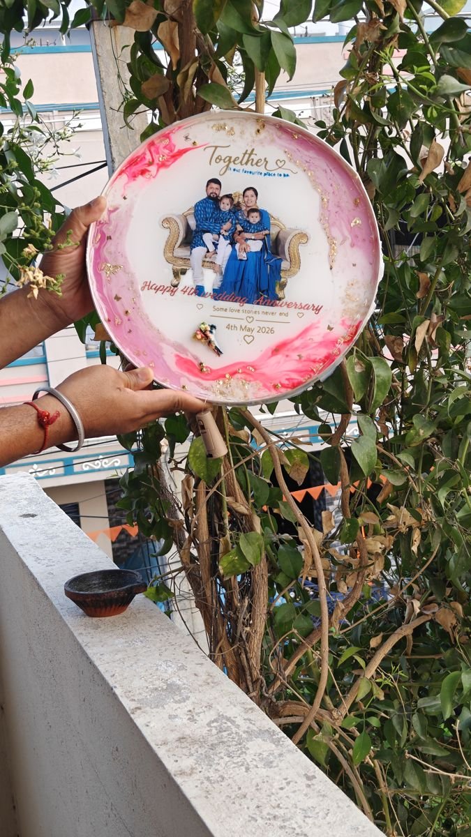 Round pink resin photo frame held in a hand