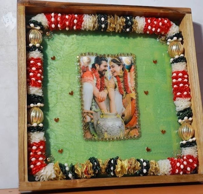 Square wooden frame with a preserved garland border
